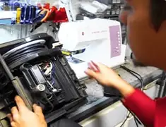 Vacuum repair technician servicing internal components on a workbench in Naperville, IL